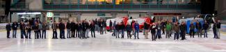 Ice rink inside - attendees inspecting ice resurfacers 